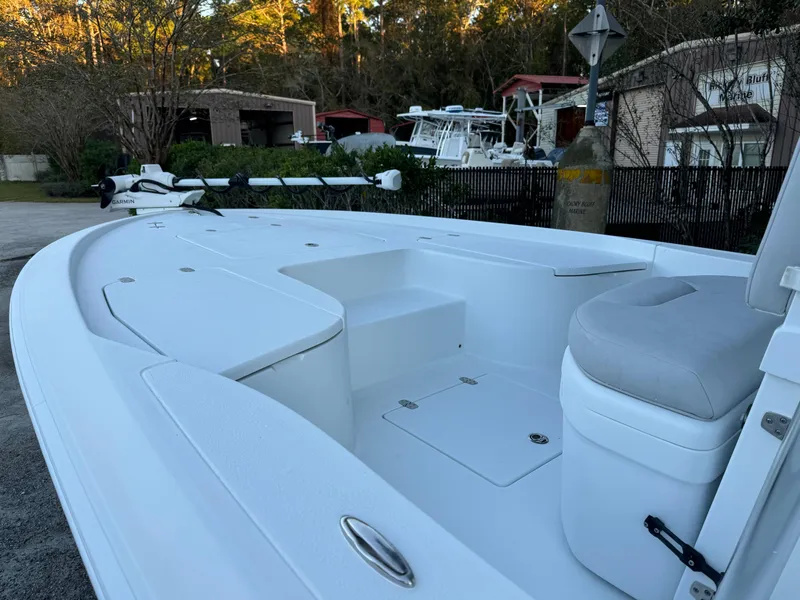 Slide: The Image of 2024 Contender 23 Bay boat with spacious deck and seating in marina setting. - 12