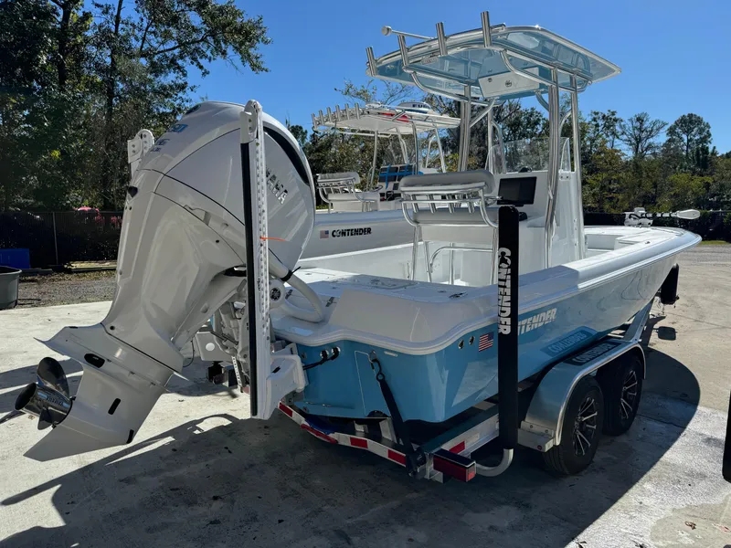 Slide: The Image of 2024 Contender 23 Bay boat on trailer with powerful outboard motor. - 21