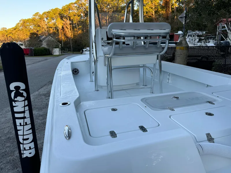 Slide: The Image of 2024 Contender 23 Bay boat, white interior, docked outdoors. - 7