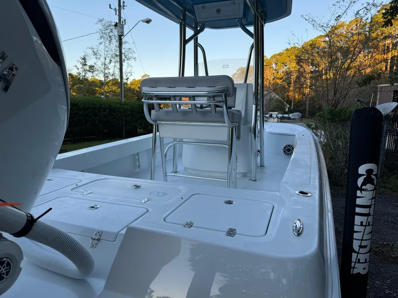 Slide: The Image of 2024 Contender 23 Bay boat, sleek design, spacious deck, outdoor setting. - 8