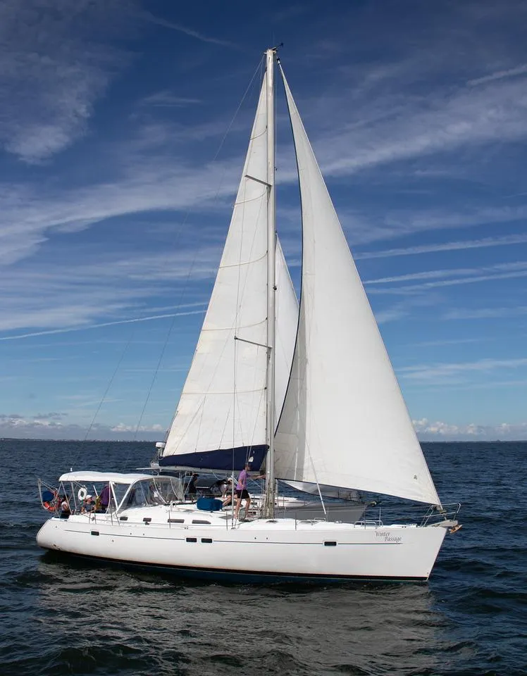 Slide: The Image of 2005 Beneteau Oceanis 473 sailing on open water under clear skies. - 4
