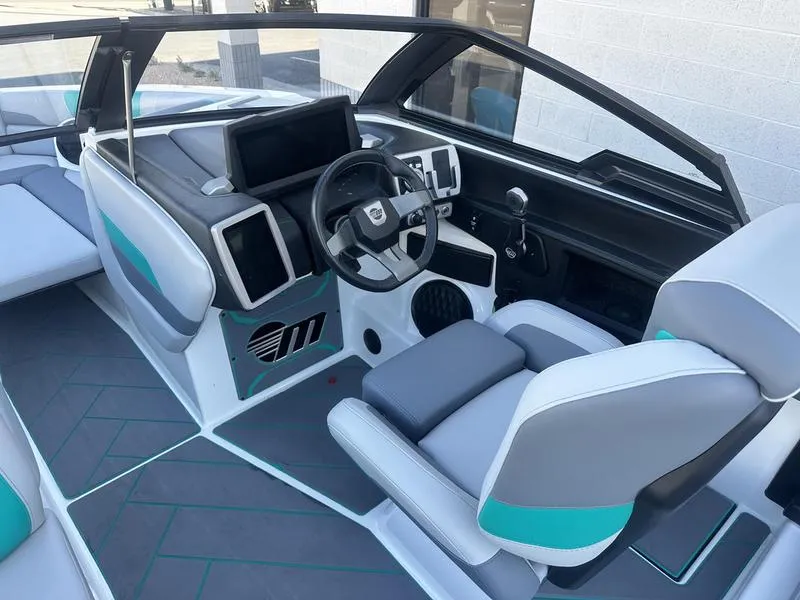 Slide: The Image of 2023 Malibu 26 LSV boat interior with modern dashboard and seating. - 14