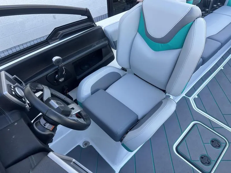 Slide: The Image of 2023 Malibu 26 LSV boat interior with modern seating and steering wheel. - 16