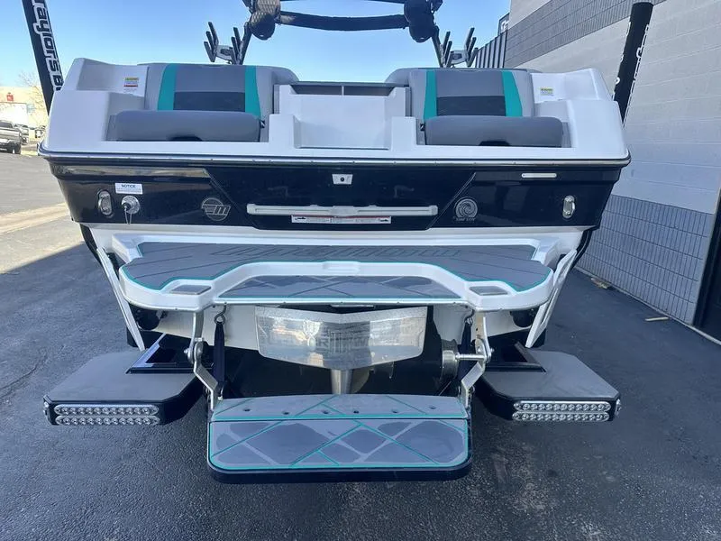 Slide: The Image of 2023 Malibu 26 LSV boat rear view with swim platform and seating. - 7