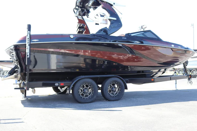 Slide: The Image of 2020 Centurion Fi23 boat on a trailer, black and red exterior. - 4