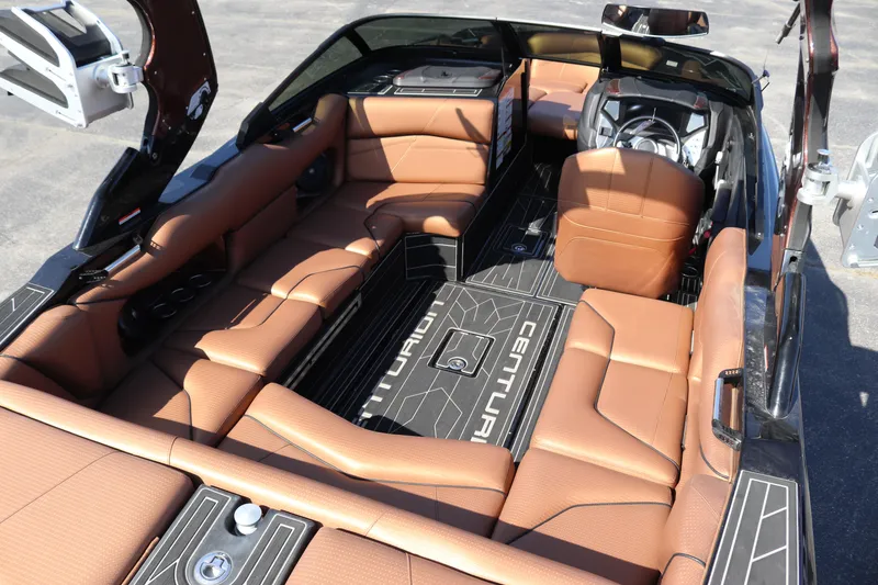 Slide: The Image of 2020 Centurion Fi23 boat interior with brown leather seats and black flooring. - 6