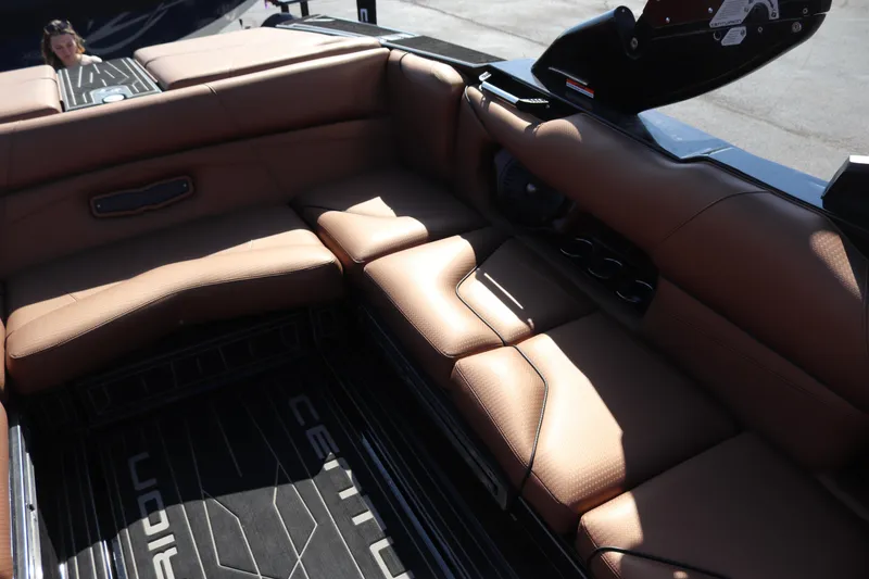 Slide: The Image of 2020 Centurion Fi23 boat interior with brown leather seating and black accents. - 8