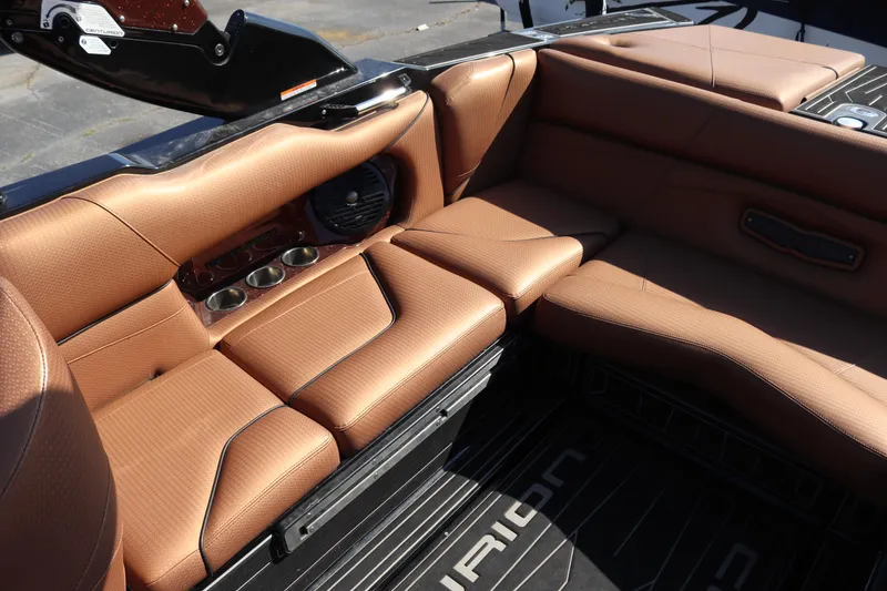 Slide: The Image of 2020 Centurion Fi23 boat interior with brown leather seating and cup holders. - 9
