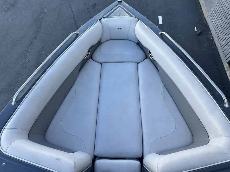 Slide: The Image of 2010 Supra Launch 24V Worlds Edition boat bow seating area with gray upholstery. - 7