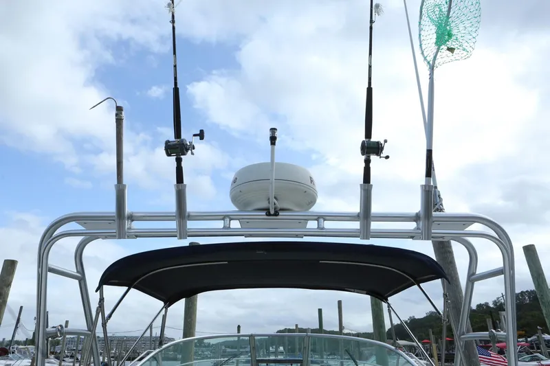 Slide: The Image of Fishing rods and equipment on a 2004 Sea Ray 290 Amberjack boat. - 12