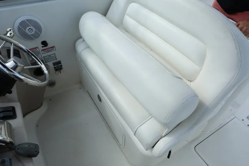 Slide: The Image of 2004 Sea Ray 290 Amberjack helm seat and steering wheel. - 13