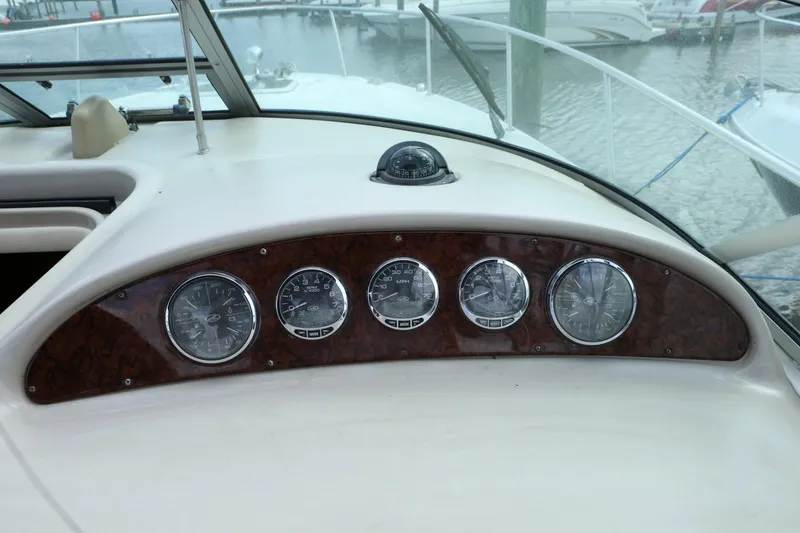 Slide: The Image of Dashboard of a 2004 Sea Ray 290 Amberjack boat with gauges and compass. - 17