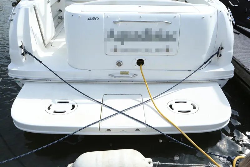 Slide: The Image of 2004 Sea Ray 290 Amberjack boat stern with dock lines and power cable. - 2