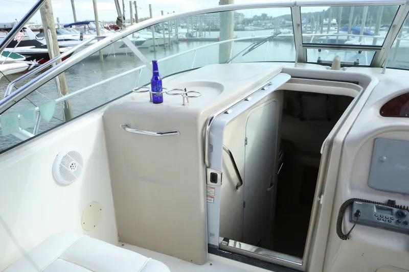 Slide: The Image of 2004 Sea Ray 290 Amberjack boat interior with open cabin door and marina view. - 20