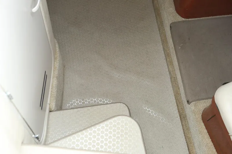 Slide: The Image of Interior carpet and steps of a 2004 Sea Ray 290 Amberjack boat. - 21