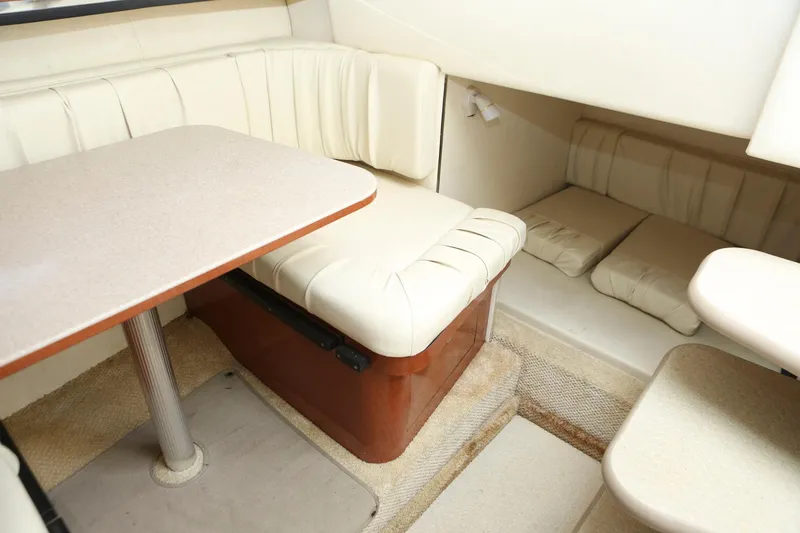 Slide: The Image of 2004 Sea Ray 290 Amberjack cabin interior with dining area and seating. - 22