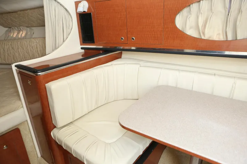 Slide: The Image of 2004 Sea Ray 290 Amberjack cabin interior with dining area and seating. - 23