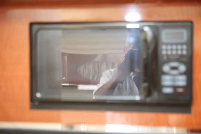 Slide: The Image of Microwave in the cabin of a 2004 Sea Ray 290 Amberjack boat. - 27