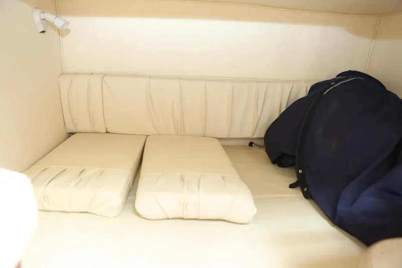 Slide: The Image of Interior cabin of a 2004 Sea Ray 290 Amberjack boat with white cushions. - 34