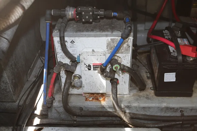 Slide: The Image of 2004 Sea Ray 290 Amberjack engine compartment with battery and wiring. - 42