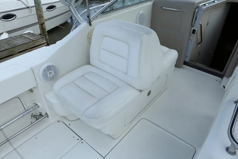 Slide: The Image of 2004 Sea Ray 290 Amberjack boat interior with white leather seating. - 7