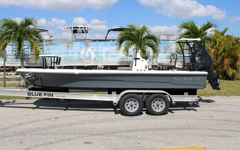 Slide: The Image of 2024 Spyder FX19 Vapor boat on Blue Fin trailer, parked outdoors. - 1