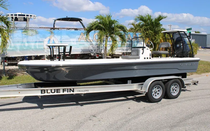 Slide: The Image of 2024 Spyder FX19 Vapor boat on Blue Fin trailer, parked outdoors. - 14
