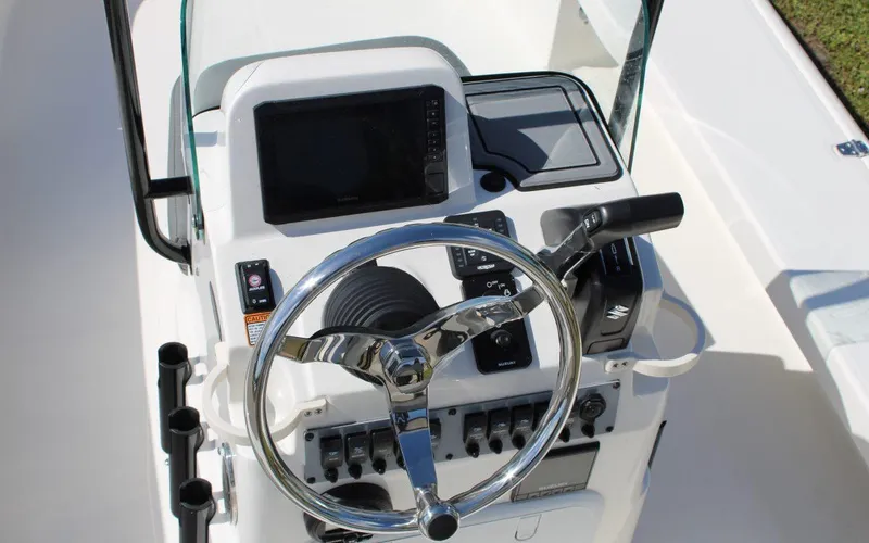 Slide: The Image of 2024 Spyder FX19 Vapor boat console with steering wheel and control panel. - 8