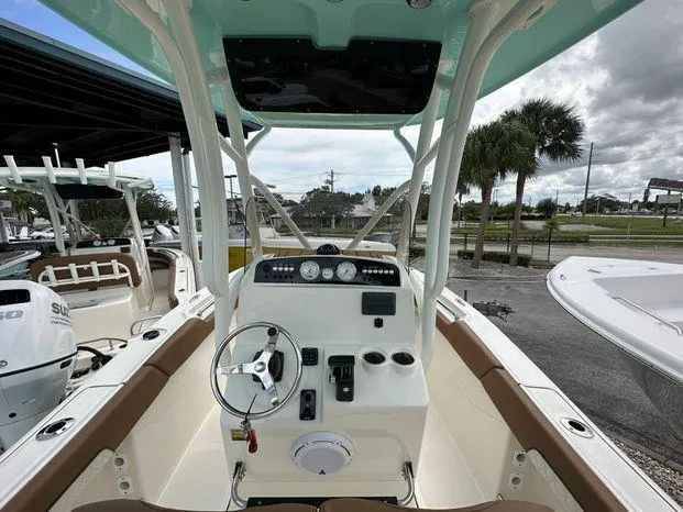 Slide: The Image of 2024 Pioneer 202 Islander boat dashboard with steering wheel and controls. - 4