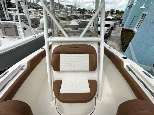 Slide: The Image of 2024 Pioneer 202 Islander boat interior with brown and white seating. - 6
