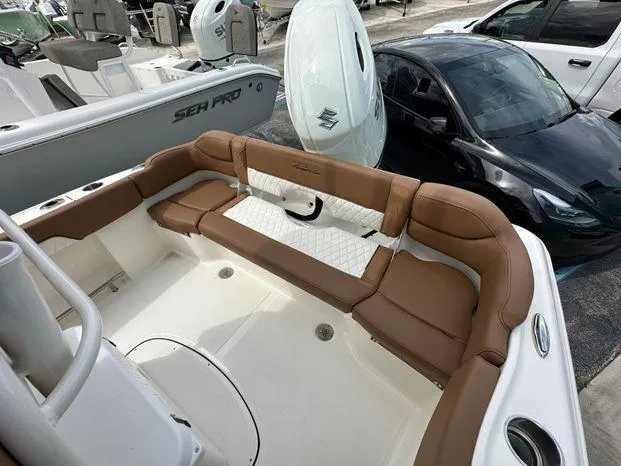 Slide: The Image of 2024 Pioneer 202 Islander boat with brown cushioned seating and white deck. - 8