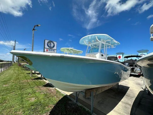 The Image of 2024 Sea Pro 239 Sport boat on display under a clear blue sky. - 1
