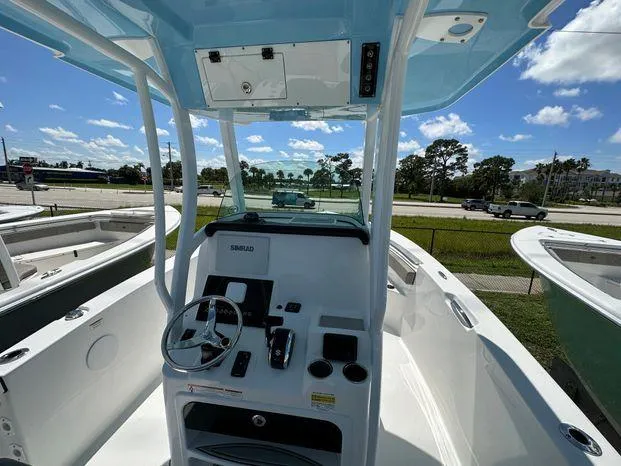 Slide: The Image of 2024 Sea Pro 239 Sport boat cockpit with steering wheel and control panel. - 4