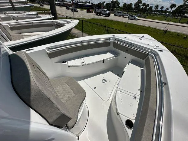 Slide: The Image of 2024 Sea Pro 239 Sport boat interior with seating and storage compartments. - 5
