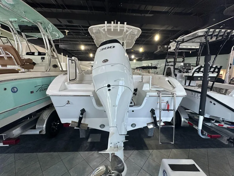 Slide: The Image of 2024 Sea Pro 239 Sport boat displayed in a showroom. - 3