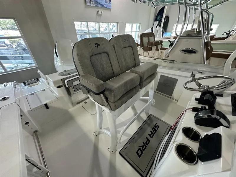 Slide: The Image of 2024 Sea Pro 239 Sport boat interior with dual seats and steering console. - 8