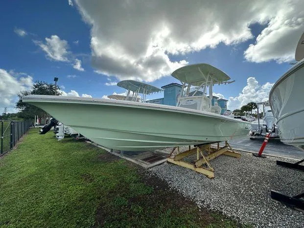 The Image of 2024 Avenger 26 Avenger boat on display under a cloudy sky. - 1