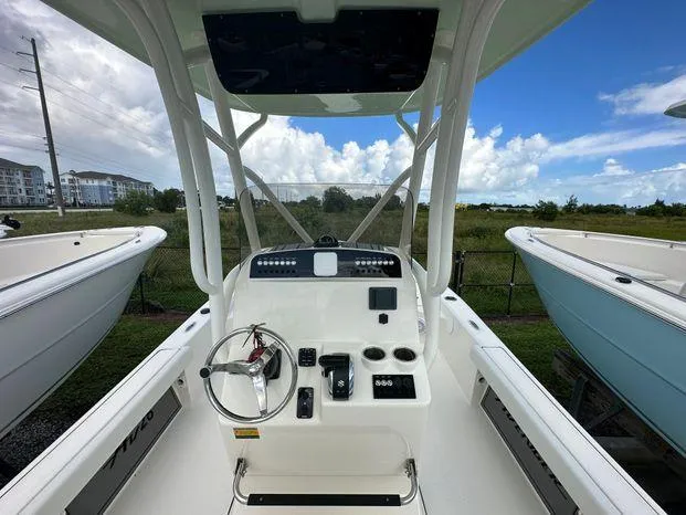 Slide: The Image of 2024 Avenger 26 Avenger boat console with steering wheel and controls. - 4