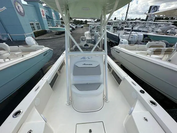 Slide: The Image of 2024 Avenger 26 Avenger boat interior at a marina, showcasing seating and console. - 6