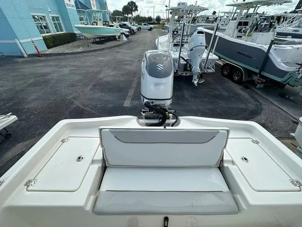 Slide: The Image of 2024 Avenger 26 Avenger boat with Suzuki outboard motor at a dealership. - 9
