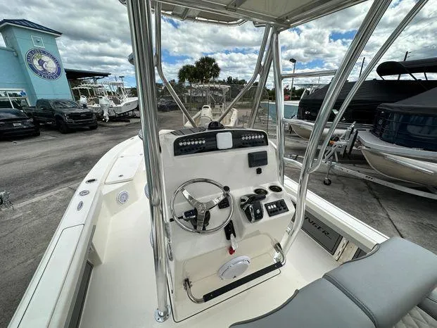 Slide: The Image of 2024 Avenger 26 Avenger boat console with steering wheel and controls. - 5