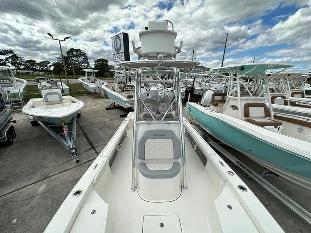 Slide: The Image of 2024 Avenger 26 Avenger boat displayed in a dealership lot. - 7