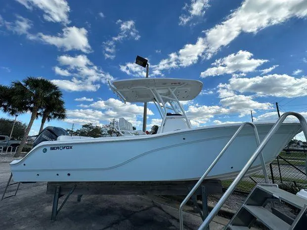 Slide: The Image of 2024 Sea Fox 248 Commander boat on display under a partly cloudy sky. - 1