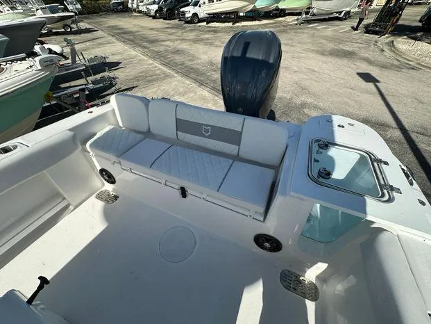 Slide: The Image of 2024 Sea Fox 248 Commander boat interior with cushioned seating and outboard motor. - 10