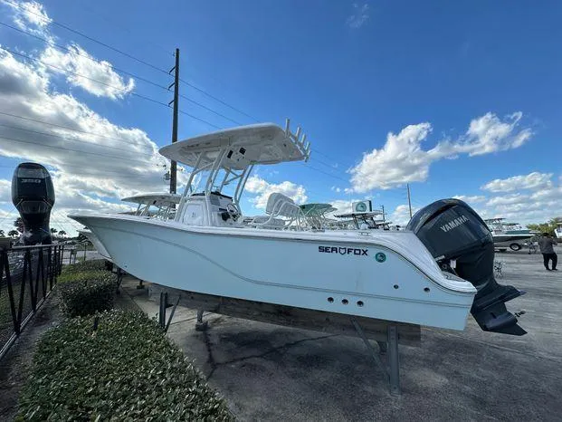 Slide: The Image of 2024 Sea Fox 248 Commander boat on display with Yamaha outboard motor. - 2