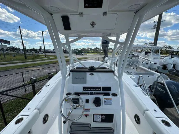 Slide: The Image of 2024 Sea Fox 248 Commander boat cockpit with steering wheel and Garmin navigation system. - 4