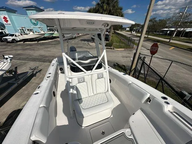 Slide: The Image of 2024 Sea Fox 248 Commander boat with T-top and seating, docked at marina. - 6