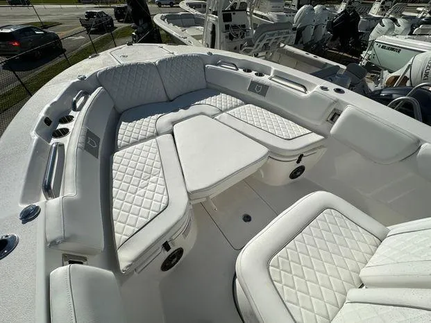 Slide: The Image of 2024 Sea Fox 248 Commander boat with luxurious white seating and table. - 8