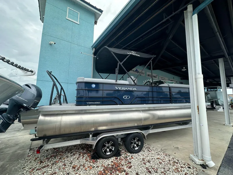 Slide: The Image of 2022 Veranda VISTA VIEW 22RC pontoon boat on trailer, parked under a shelter. - 2