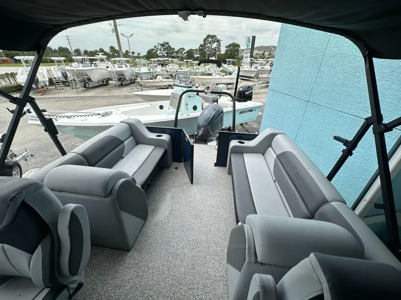 Slide: The Image of 2022 Veranda VISTA VIEW 22RC pontoon boat interior with gray seating and outdoor view. - 9